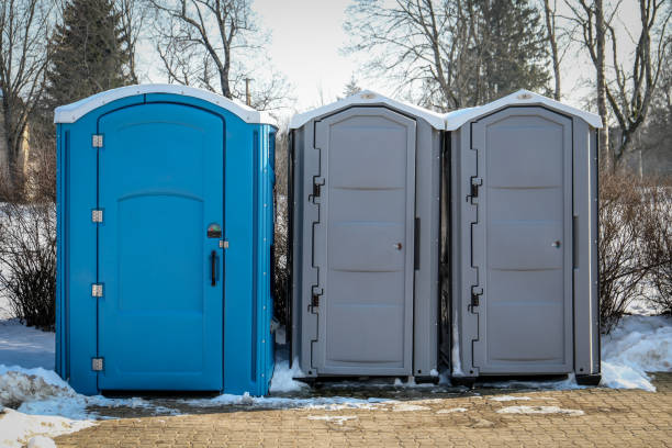 portable toilets in a snowy outdoor setting during winter. portable toilets in a snowy outdoor setting during winter.